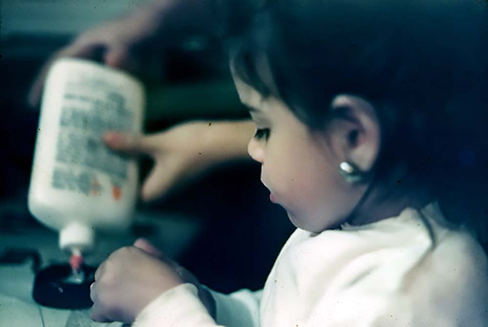 Nina with glue at age three